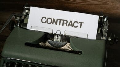 a close up of a typewriter with a sign that reads contact