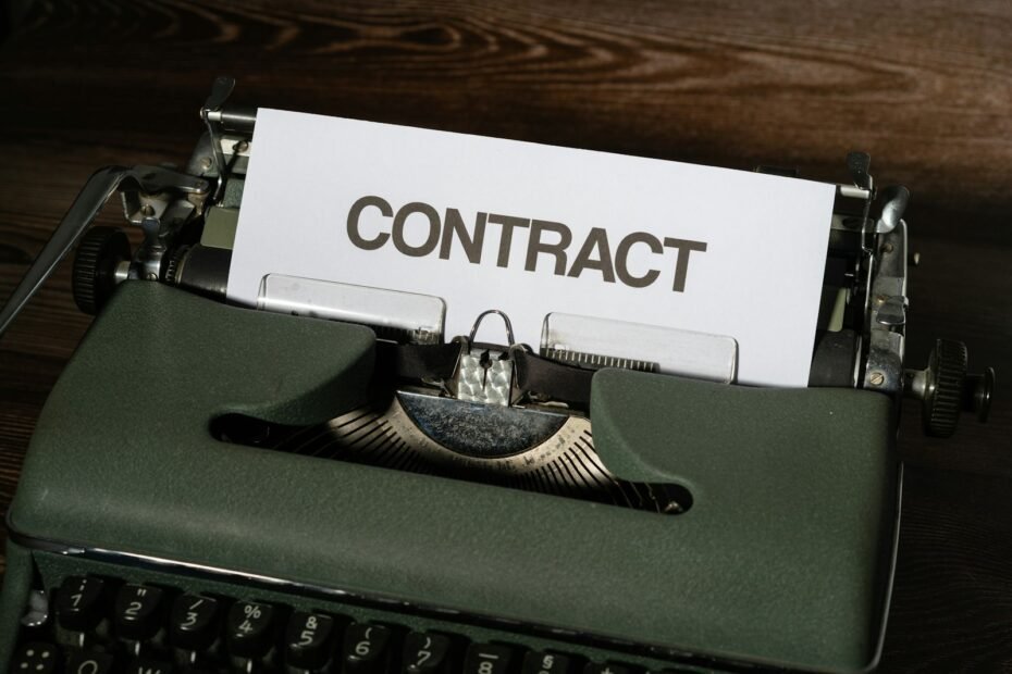 a close up of a typewriter with a sign that reads contact