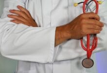 doctor holding red stethoscope